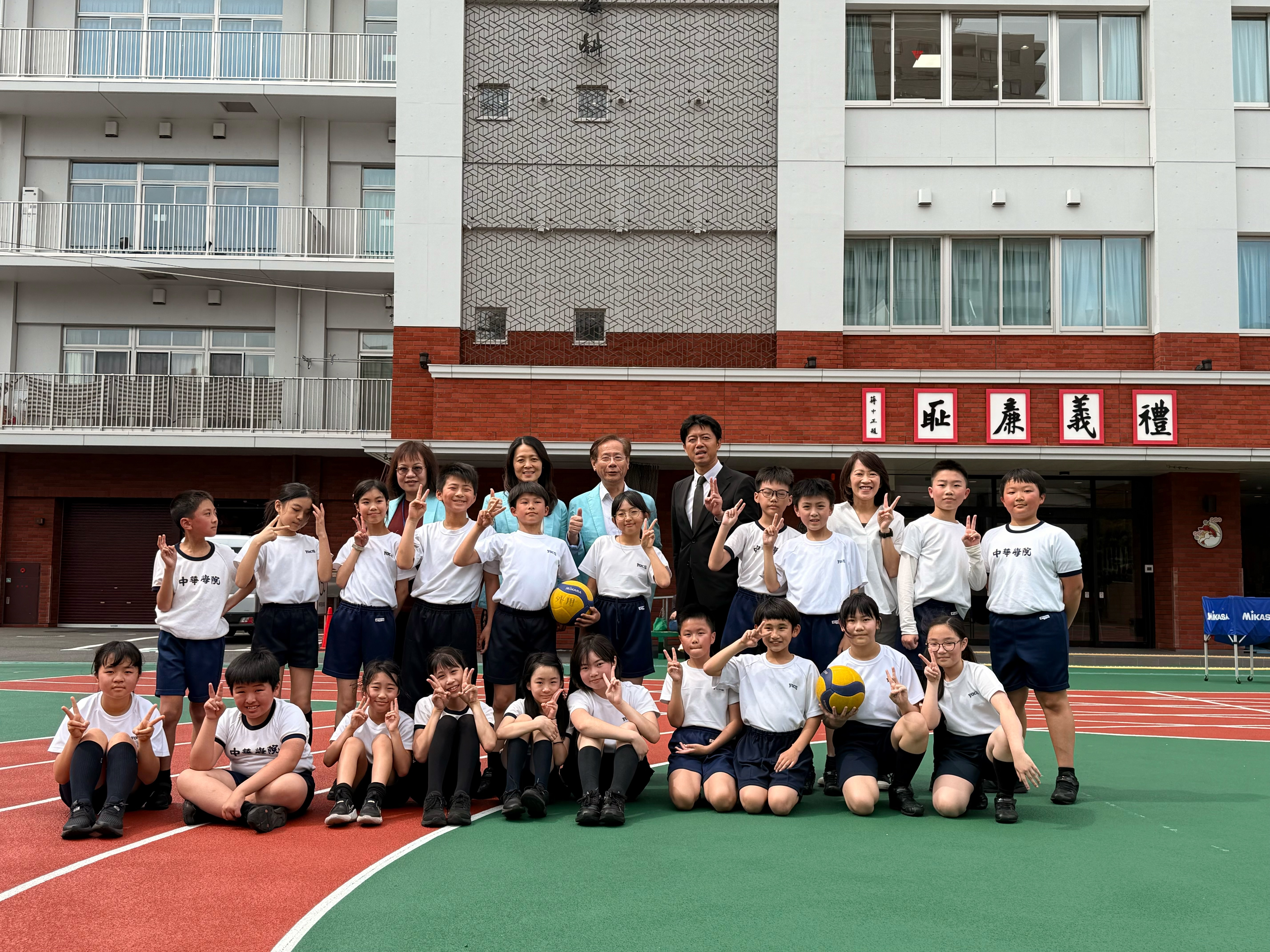 台北市國小學力評量中心工作人員與本校校長、學生合影。