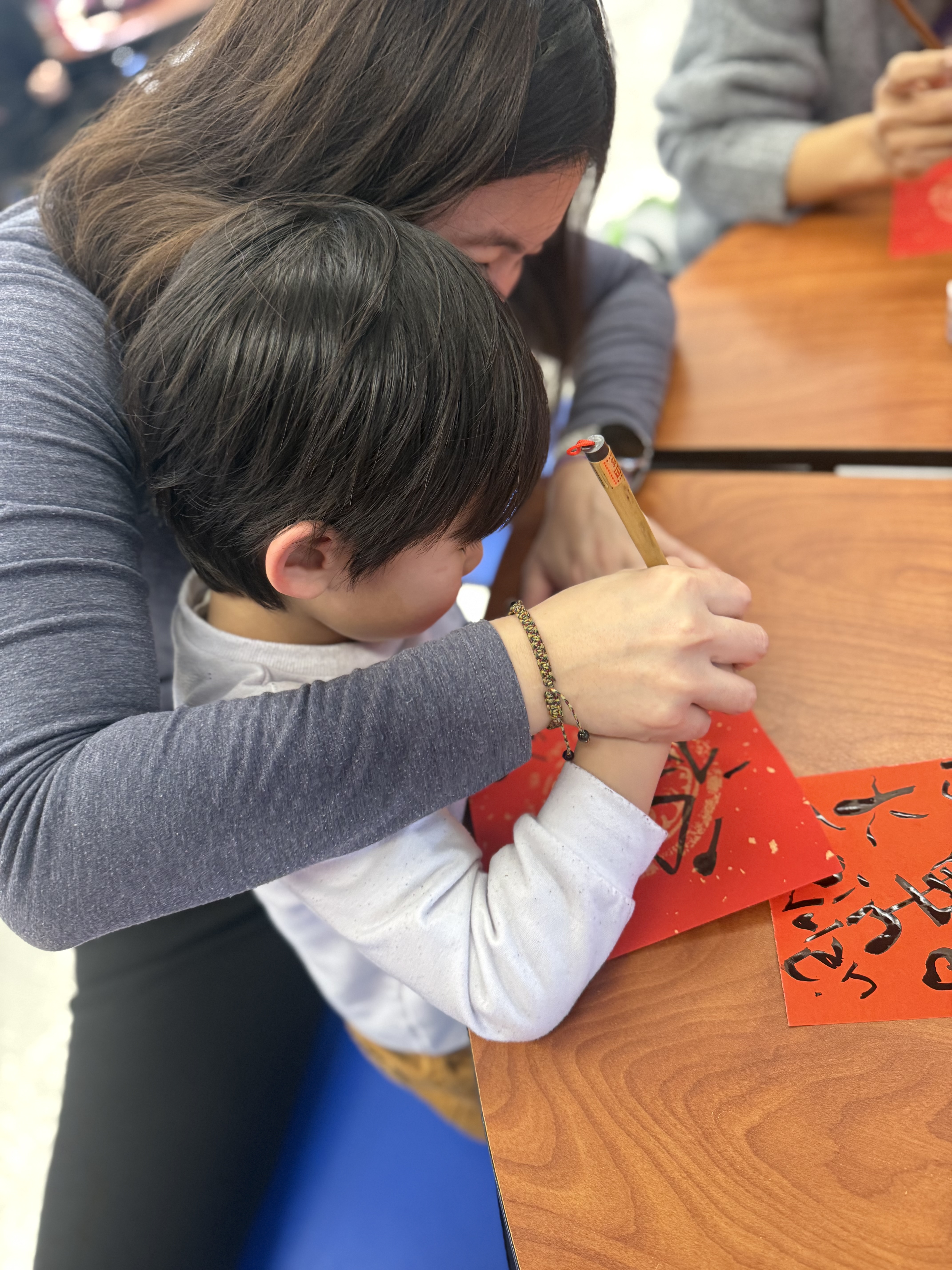 老師指導學生寫春聯